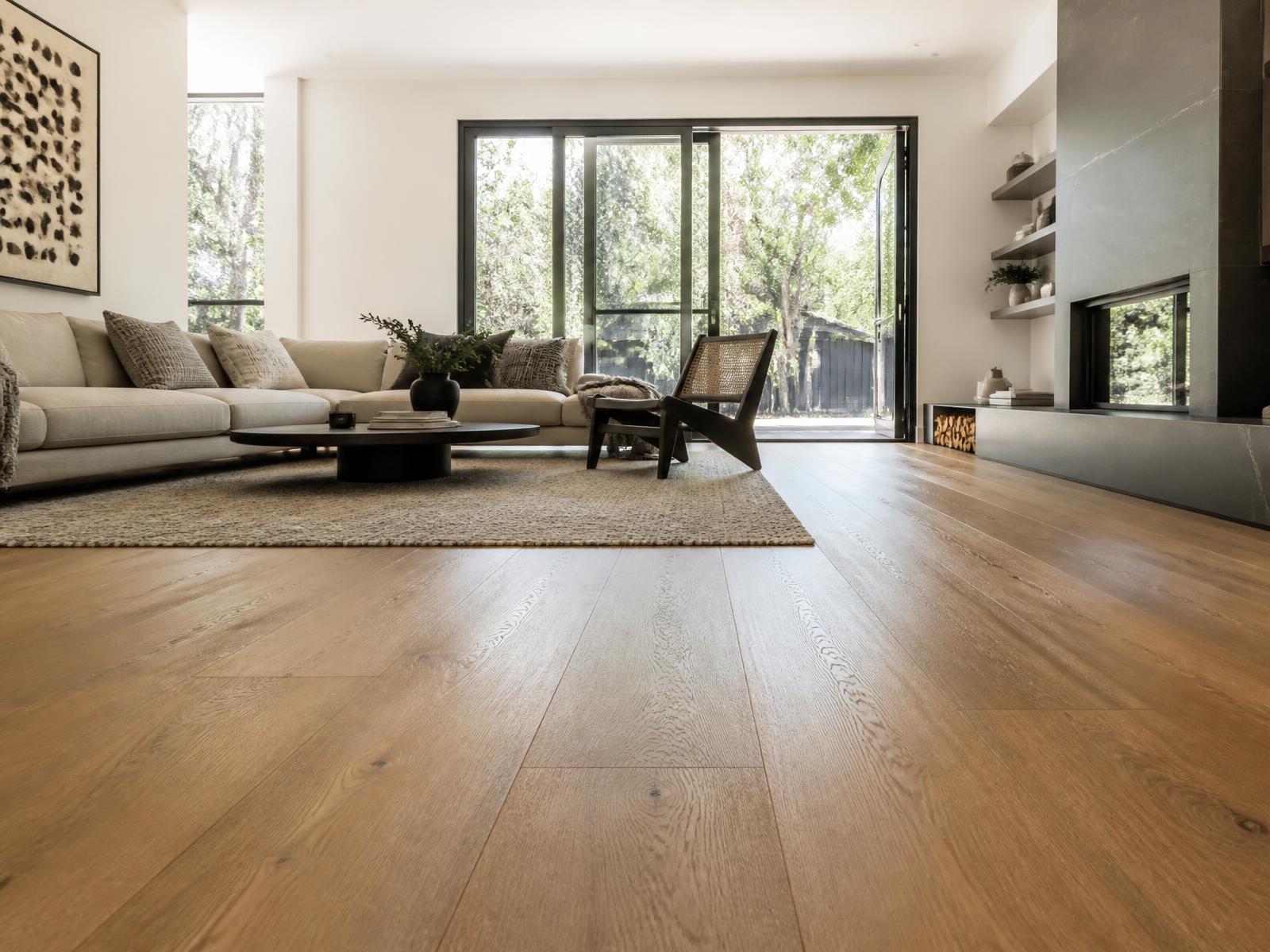 Modern living room with newly installed wide-plank hardwood flooring